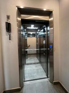 a hallway with a elevator in a building at Hotel Atenas in Barranca