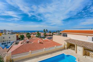 a view from the balcony of a house with a swimming pool at Villa el Yuka , heated pool in Callao Salvaje