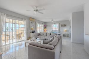 a living room with couches and a table at Villa el Yuka , heated pool in Callao Salvaje +31 photos