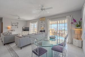 a living room with a glass table and chairs at Villa el Yuka , heated pool in Callao Salvaje