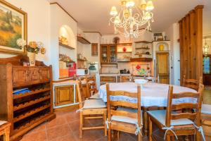 a kitchen with a table and chairs in a room at Tenuta del Normanno in Carovigno