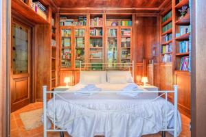 a bedroom with a bed in a room with bookshelves at Tenuta del Normanno in Carovigno
