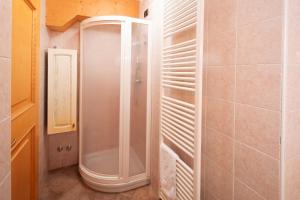 a shower with a glass door in a bathroom at Piaz de Vich in Vigo di Fassa +13 photos