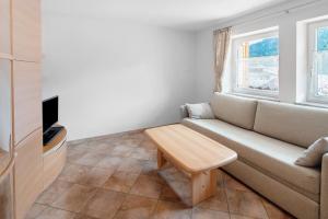 a living room with a couch and a table at Piaz de Vich in Vigo di Fassa