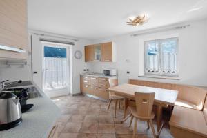 a kitchen with a table and chairs in it at Piaz de Vich in Vigo di Fassa
