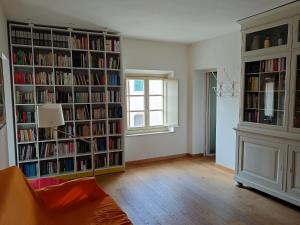 a living room with bookshelves filled with books at Calci - dal monte al mare in Calci