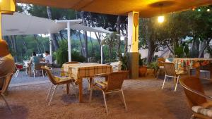 a table and chairs sitting under an umbrella at Pensión las 3 Golondrinas in Santa Eularia des Riu