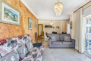 a living room with a couch and a chair at La cargolera in L'Escala