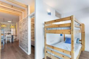 a bedroom and a living room with a bunk bed at Milailea in Tacoronte