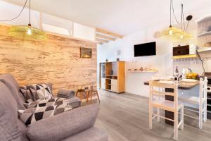 a living room and kitchen with a couch and a table at Milailea in Tacoronte