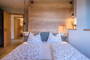 a bedroom with a bed with pillows at Thaleralm in Obereggen