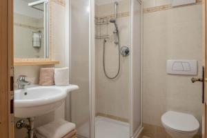 a bathroom with a shower and a sink and a toilet at Thaleralm in Obereggen +20 photos