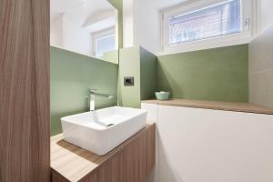 a bathroom with a white sink and a mirror at Gemhouse Smeraldo garda lake in Gargnano +23 photos