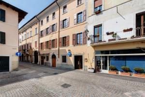 an empty street in a town with buildings at Gemhouse Smeraldo garda lake in Gargnano