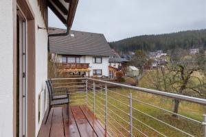 a chair sitting on a balcony of a house at Haus Luise in Lenzkirch in Lenzkirch