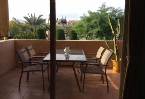 a table and chairs on a balcony with a view at Los Almendros in Vera