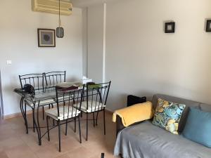 a living room with a table and chairs and a couch at Los Almendros in Vera +25 photos