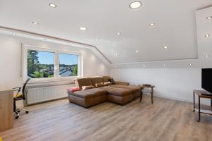 a living room with a couch and a large window at Ferienwohnung Markelfingen in Radolfzell am Bodensee