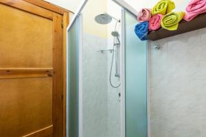 a bathroom with a shower with a glass door at Solemarevacanze Villasimius in Villasimius +15 photos
