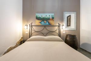 a bedroom with a bed and a painting on the wall at Solemarevacanze Villasimius in Villasimius