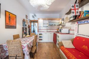 a kitchen with a table and chairs in a room at Solemarevacanze Villasimius in Villasimius