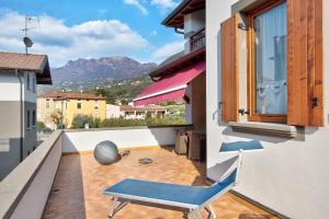 a blue chair on the balcony of a house at Wakesurfhouse 2 in Sulzano