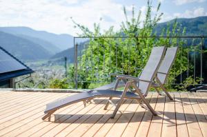 a rocking chair sitting on a deck with a view at Vordersbergerhof in Hausach