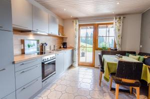 a kitchen with a table and a dining room at Vordersbergerhof in Hausach +23 photos