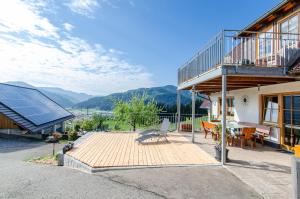 a house with a deck with a table and a balcony at Vordersbergerhof in Hausach