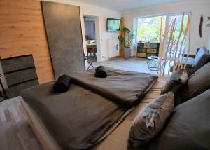 a living room with a large bed and a couch at Apartment Flora in Stockach