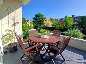 a wooden table and chairs on a patio at Apartment Flora in Stockach +27 photos