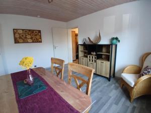 a living room with a wooden table and chairs at Apartment Flora in Stockach