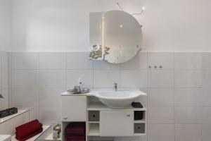 a white bathroom with a sink and a mirror at Wohnung Hildesheim in Hildesheim +17 photos