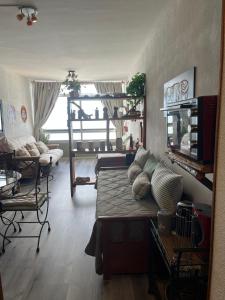 a living room with a bed with pillows on it at Playa Club in Miramar