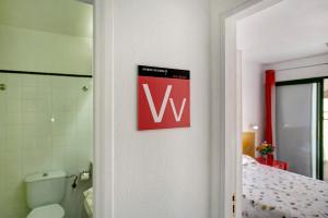 a bathroom with aww sign on the door of a room at Silent Flat in Puerto Rico de Gran Canaria +15 photos