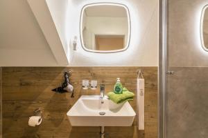 a bathroom with a sink and a mirror at Treibholz - Feriendomizil Ostsee in Schönberger Strand +37 photos