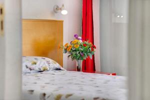a bedroom with a bed with a vase of flowers at Silent Flat in Puerto Rico de Gran Canaria