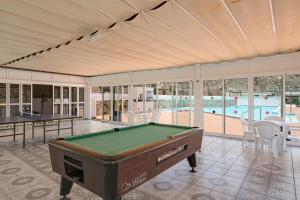 a room with a pool table and a swimming pool at Silent Flat in Puerto Rico de Gran Canaria