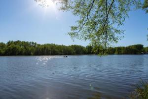 a person in a boat on a large lake at Privatzimmer R und C Lohnherr in Lehnin