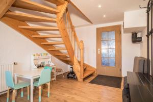 a living room with a table and chairs and a staircase at Ferienwohnung am Hopfengarten in Tettnang