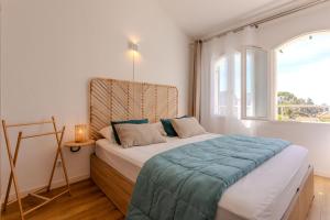 a bedroom with a bed and a large window at Villa Alpaga Esterel Vue Mer in Saint-Raphaël +23 photos