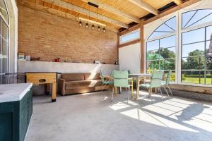 a living room with a table and chairs and a couch at Kranichblick in Lüdershagen