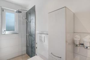 a bathroom with a shower with a glass door at Modern eingerichtetes Apartment in Achern +22 photos