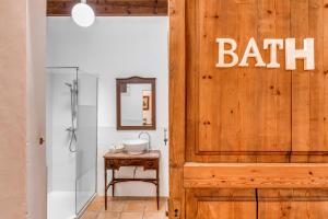 a bathroom with a bath sign on a wooden door at Finca Buniferri in Llucmajor +20 photos