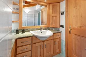 a bathroom with a sink and a mirror at Mansarda Combo in Bormio +24 photos