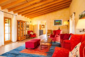 a living room with red furniture and a table at Finca Can Xerpeta in Son Servera