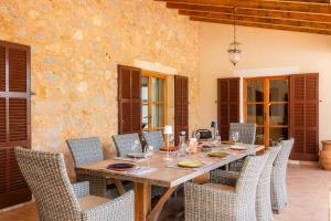 a dining room with a wooden table and chairs at Finca Can Xerpeta in Son Servera