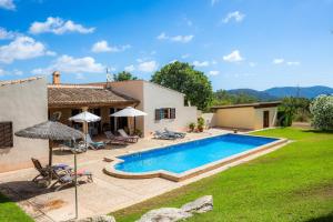 a house with a swimming pool in a yard at Finca Can Xerpeta in Son Servera