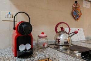 a kitchen counter with a toaster and a tea kettle at Kyma monolocale ad Otranto in Otranto