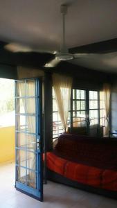 a bedroom with a bed in a room with windows at Appartement à Natangue 1 in Saly Portudal +10 photos